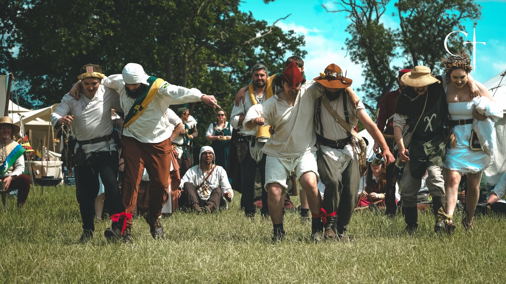 Marchers competing in a three-legged race during Sports Day - Marcus and Dick won